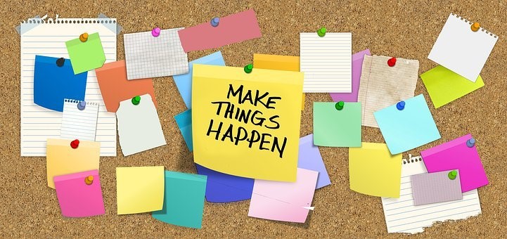 image of a board that a bulletin board with a note that says "Make Things Happen"