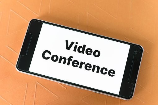 Have a tablet with the words in black letters that say "Video Conference" with a complete white background