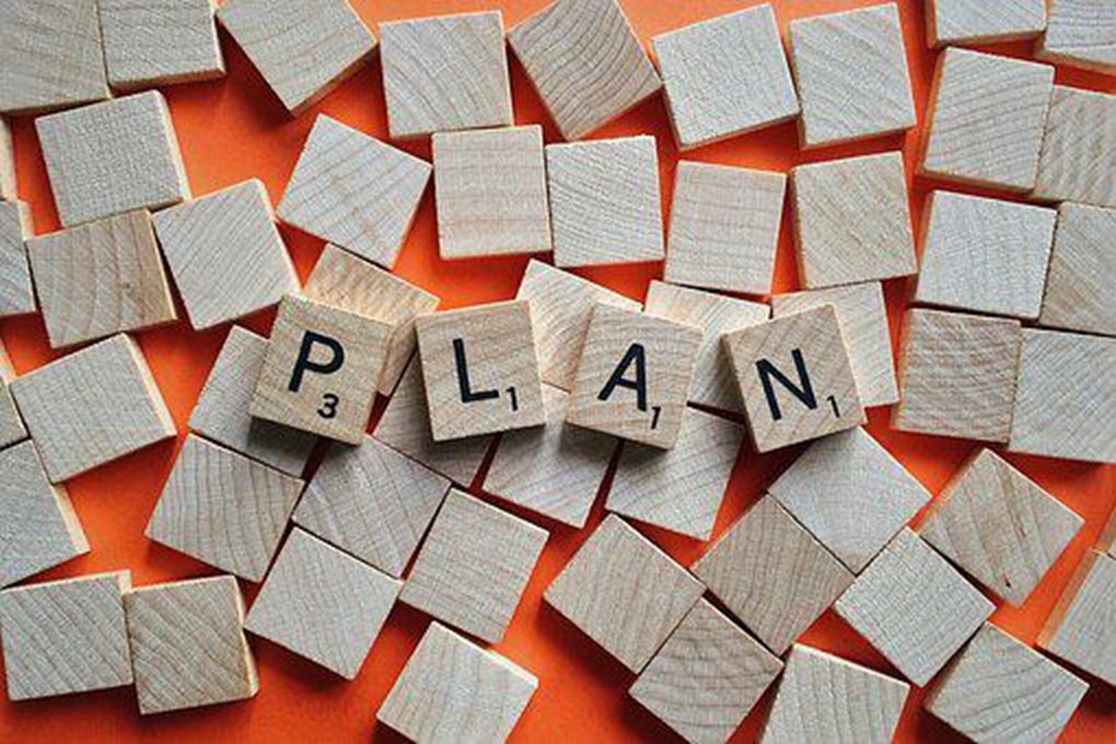Has the word "plan" spelled out from puzzle pieces